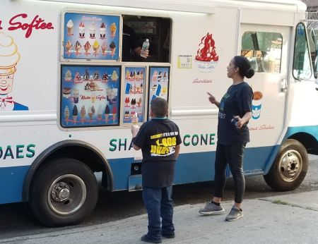 child wearing 1-800-HURT-911 tshirt at Mr. Softee truck at our Bronx office on Gunhill Rd
